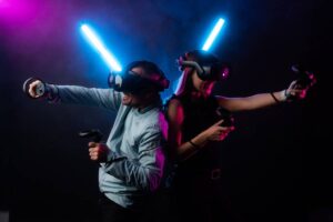 Two people back to back with light sticks